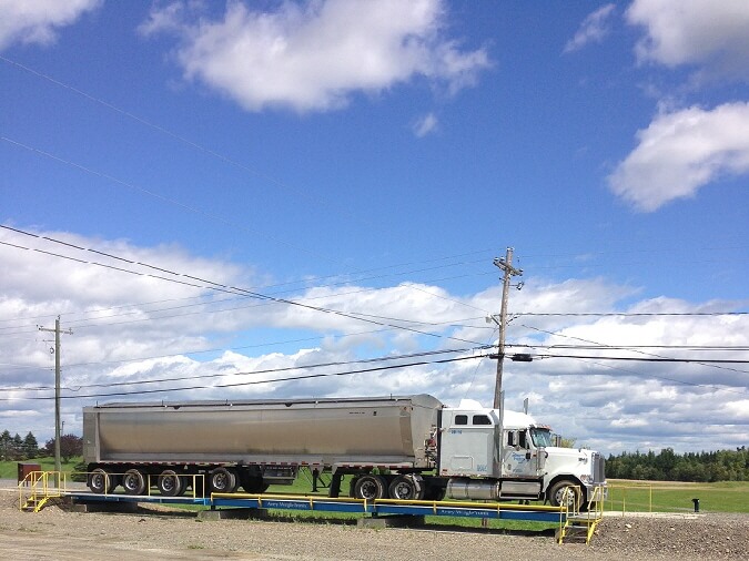 white Truck in front of bin